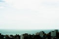 Beautiful panorama seaside town view real natural landscape photo background. Rooftops. Sea merges horizon skyline. Calm