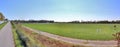 Beautiful panorama of spring landscapes with green grass and a clear blue sky Royalty Free Stock Photo