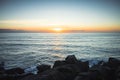 Beautiful panorama of a sunset with the sun about to hide in the Pancake Rocks, New Zealand