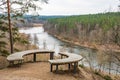 Beautiful panorama of valley with forest and river view from a hill with wooden circular bench
