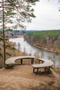Beautiful panorama of valley with forest and river view from a hill with wooden circular bench