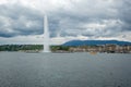 Beautiful panorama view of Geneva lake and Jet d`eau fountain and medieval buildings on clouds sky background Royalty Free Stock Photo