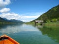 Wonderfully panorama view with a turquoise blue austrian lake with green mountains and wooden houses