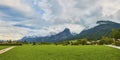 Beautiful panoramic landscape with lush green grass land and Alpine mountains near Wolfgangsee lake in Austria Royalty Free Stock Photo