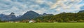 Beautiful panoramic landscape with lush green grass land and Alpine mountains near Wolfgangsee lake in Austria Royalty Free Stock Photo