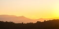 Beautiful panoramic mountain landscape with hazy peaks and foggy valley at sunset Royalty Free Stock Photo