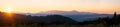 Beautiful panoramic mountain landscape with hazy peaks and foggy valley at sunset Royalty Free Stock Photo