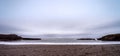 Beautiful panoramic shot of a pebbles beach taken on a cloudy winter day at Truman Track, New Zealand Royalty Free Stock Photo