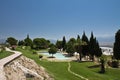 Beautiful panoramic sight of natural hot limestone spring pools in pamukkale park with pine trees, turkey