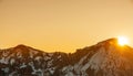 Beautiful panoramic sunrese over the mountains and  snow-covered hills. Royalty Free Stock Photo