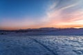 Beautiful panoramic sunset over the mountains and  snow-covered hills. Royalty Free Stock Photo