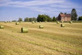 Beautiful panoramic view of afield with straw bales and a blue sky with clouds