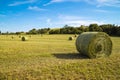 Beautiful panoramic view of afield with straw bales and a blue sky with clouds
