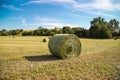 Beautiful panoramic view of afield with straw bales and a blue sky with clouds