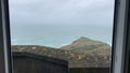 Beautiful panoramic view from a balcony of sea and cliffs under a cloudy sky Royalty Free Stock Photo