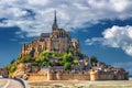 Beautiful panoramic view of famous Le Mont Saint-Michel tidal island with blue sky. Normandy, northern France Royalty Free Stock Photo
