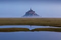 Beautiful panoramic view of famous Le Mont Saint-Michel tidal island with deep blue water and clear reflections. Royalty Free Stock Photo