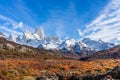 Beautiful panoramic view of Fitz roy mountains with white snow peak with colorful red orange leaves tree in sunny blue sky day, Royalty Free Stock Photo