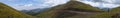 Beautiful panoramic view of green mountains with dangerous gravel road. Ketmen or Ketpen mountains gorge and mountain pass.