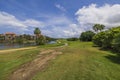 Beautiful panoramic view of hotel grounds with golf course on blue sky with white clouds in background. Royalty Free Stock Photo