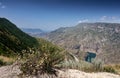 Beautiful panoramic view of the mountains with bushes, flowers and a blue-green river on a sunny summer day. Sulak Canyon Royalty Free Stock Photo