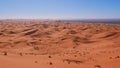 Beautiful panoramic view over the sand dunes of desert Erg Chebbi near Merzouga, Morocco, Africa in the midday sun. Royalty Free Stock Photo