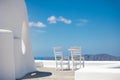 Romantic table set-up in Santorini Greece. White architecture and table for two. Love concept in romantic travel destination Royalty Free Stock Photo