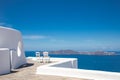 Beautiful travel background, two white chairs with white architecture on Santorini island, Greece. Luxury vacation Royalty Free Stock Photo