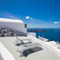 Luxury travel destination in Santioni island, Greece. White houses and caldera sea view with loungers under blue sky, romance Royalty Free Stock Photo