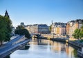 Beautiful panoramic view from the Seine River to the bridge and the city landscape on a sunny summer day. Paris, France Royalty Free Stock Photo