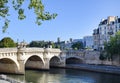 Beautiful panoramic view from the Seine River to the bridge and the city landscape on a sunny summer day. Paris, France Royalty Free Stock Photo