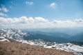 A beautiful view of the snow-capped mountains of the Carpathians from the top of Goverly in spring in a beautiful sunny