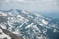 A beautiful view of the snow-capped mountains of the Carpathians from the top of Goverly in spring in a beautiful sunny