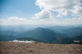 A beautiful view of the snow-capped mountains of the Carpathians from the top of Goverly in spring in a beautiful sunny day with l