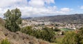 Beautiful panoramic view of Teror between hills covered by green vegetation on sunny day in Gran Canaria island, Spain Royalty Free Stock Photo