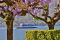 Beautiful panoramic view to ferry boat moving on the lake Como at Bellagio in early spring sunny day.