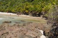 Beautiful paradise beach with rock formations, clear water and dense vegetation Royalty Free Stock Photo