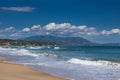 Beautiful sea sandy beach, waves, white foam, blue sky, blue water, white clouds. Royalty Free Stock Photo