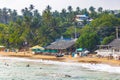 Beautiful paradise tropical Mirissa beach waves parasols tourists Sri Lanka