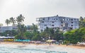 Beautiful paradise tropical Mirissa beach waves parasols tourists Sri Lanka