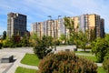 Beautiful park against tall houses, buildings. skyscrapers landscape. Spring, summer street in Ukrainian city Dnipro Ukraine Royalty Free Stock Photo