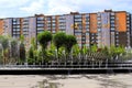 A beautiful park with fountains and trees against backdrop of tall houses, buildings and skyscrapers. Urban landscape. Spring, Royalty Free Stock Photo
