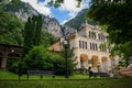 A beautiful park somewhere in a mountain resort in Romania, Europe. A beautiful imposing building, many green trees and plants.