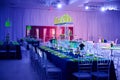 Beautiful party room set up for a wedding or social event in the ballroom orchid and lucite center piece green Royalty Free Stock Photo