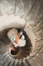 Beautiful, passionate wedding couple posing on stairs