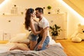 Beautiful passionate young couple hugging on the bed at home. Intimate and sensual moments of a couple making love in the bedroom Royalty Free Stock Photo