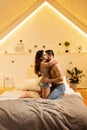 Beautiful passionate young couple hugging on the bed at home. Intimate and sensual moments of a couple making love in the bedroom Royalty Free Stock Photo