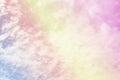 Beautiful pastel color with rainbow shade on white fluffy clouds, colorful blue sky on background, upward view and copy space Royalty Free Stock Photo