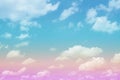 Beautiful pastel color with rainbow shade on white fluffy clouds, colorful blue sky on background, upward view and copy space Royalty Free Stock Photo