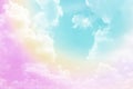 Beautiful pastel color with rainbow shade on white fluffy clouds, colorful blue sky on background, upward view and copy space